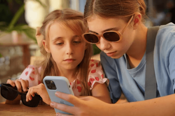 young girls playing with mobile phone