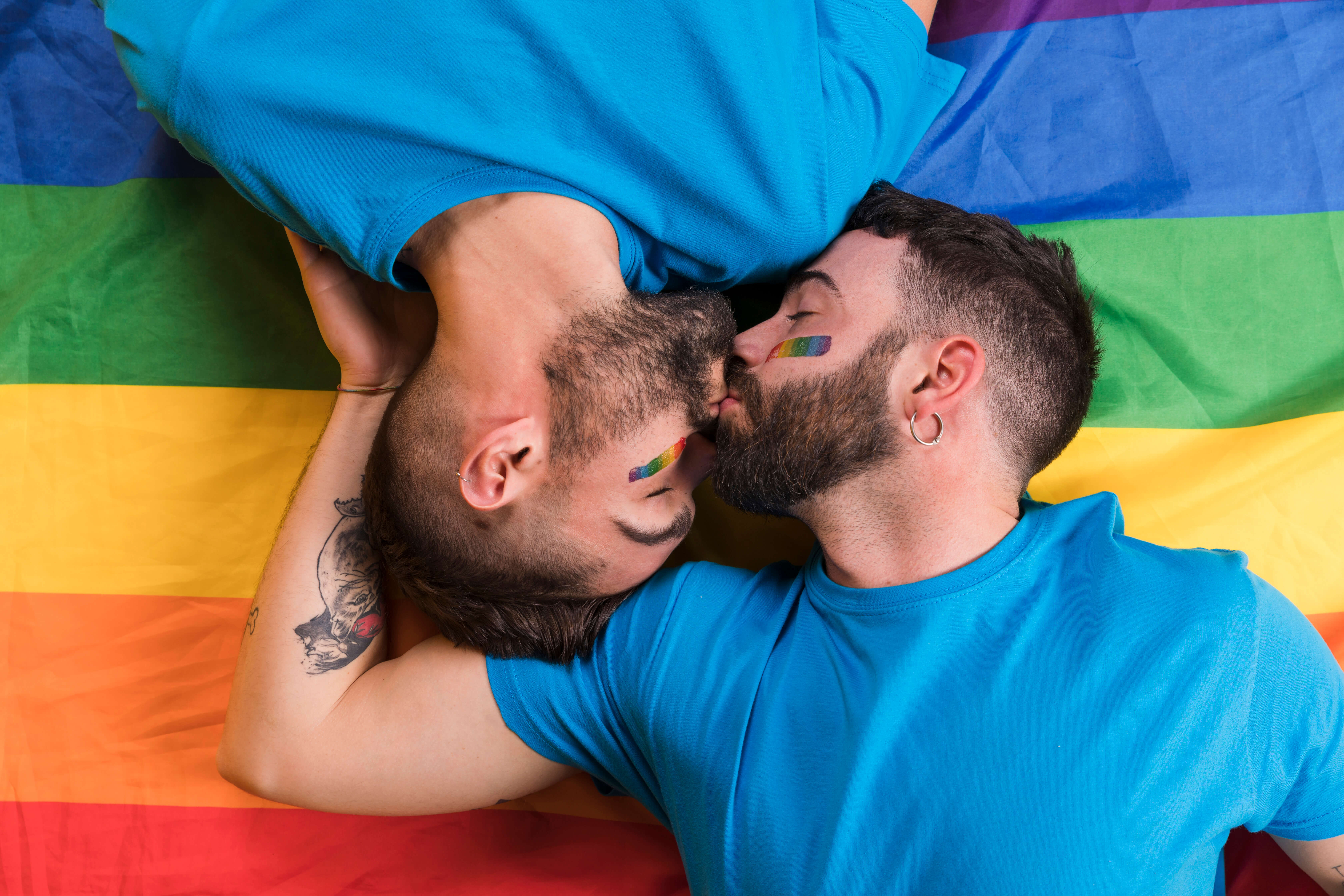 couple men laying kissing lgbt flag